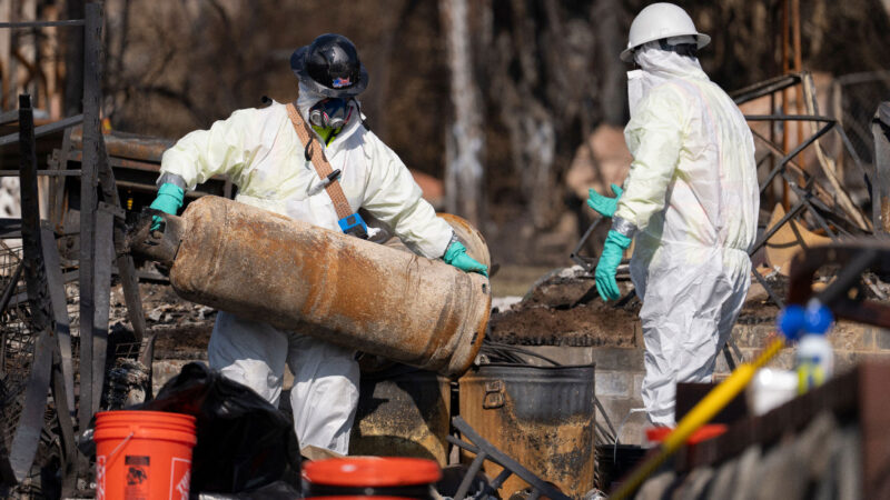 Crews from the EPA remove dangerous propane tanks from an Altadena property.