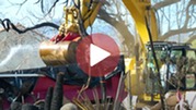 Excavator moving debris